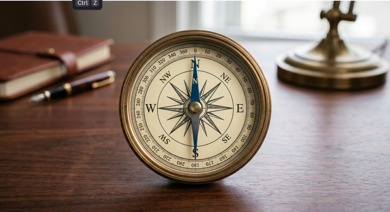 A brass compass on a desk, representing True North orientation